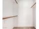Walk in closet featuring hardwood shelving and rod for hanging storage at 4406 E Carter Dr, Phoenix, AZ 85042