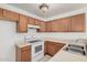 Functional kitchen featuring wood cabinets, white countertops and a double basin sink at 4406 E Carter Dr, Phoenix, AZ 85042