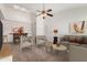 Bright living room featuring neutral furniture, a ceiling fan, and an open dining area bathed in natural light from the skylight at 4406 E Carter Dr, Phoenix, AZ 85042