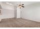 Bright, spacious living room featuring neutral carpeting, a ceiling fan, and natural light at 4406 E Carter Dr, Phoenix, AZ 85042