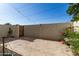 Private backyard featuring a concrete patio, stucco walls, plants, gate, and a charming string of lights at 4722 W Via Cynthia --, Glendale, AZ 85301