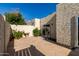 Secluded backyard featuring a concrete patio, stucco walls, landscaping, and a charming string of lights at 4722 W Via Cynthia --, Glendale, AZ 85301