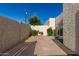 Enclosed backyard featuring a concrete patio, stucco walls, decorative plants, and a charming string of lights at 4722 W Via Cynthia --, Glendale, AZ 85301