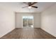 Large bedroom featuring wood-look floors and sliding glass doors at 4722 W Via Cynthia --, Glendale, AZ 85301
