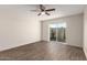 Sunny bedroom with wood-look floors and sliding glass door to patio at 4722 W Via Cynthia --, Glendale, AZ 85301