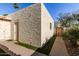 Exterior view of the home featuring stucco walls, a walkway, and partial landscaping at 4722 W Via Cynthia --, Glendale, AZ 85301