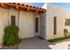 Charming front entrance featuring a security door, tile roof, and fresh landscaping at 4722 W Via Cynthia --, Glendale, AZ 85301