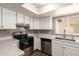 Bright, modern kitchen with stainless steel appliances, white cabinetry and updated countertop at 4722 W Via Cynthia --, Glendale, AZ 85301