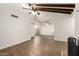 Spacious living room featuring wood-look floors and sliding door access to the patio at 4722 W Via Cynthia --, Glendale, AZ 85301