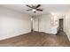 Spacious main bedroom with wood floors and a ceiling fan, leading to the bathroom at 4722 W Via Cynthia --, Glendale, AZ 85301