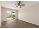 Bright bedroom featuring hardwood flooring and sliding door to a patio at 4722 W Via Cynthia --, Glendale, AZ 85301