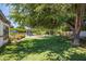 Lush backyard with mature trees, a sparkling pool, and various outdoor seating areas, perfect for relaxation at 5051 E Lafayette Blvd, Phoenix, AZ 85018