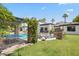 Expansive backyard featuring a pool, covered patio, lush lawn, and mature landscaping for outdoor enjoyment at 5051 E Lafayette Blvd, Phoenix, AZ 85018