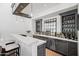 Modern bar area with white countertops, sleek cabinetry, and stylish pendant lighting at 5051 E Lafayette Blvd, Phoenix, AZ 85018