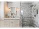 Well lit bathroom featuring a marble sink and glass-enclosed shower with stone tiling at 5051 E Lafayette Blvd, Phoenix, AZ 85018