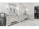 Elegant bathroom with marble floors, dual sinks, vanity, and walk-in closet at 5051 E Lafayette Blvd, Phoenix, AZ 85018