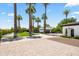 Long driveway leading to an elegant home with mature palm trees and meticulous landscaping at 5051 E Lafayette Blvd, Phoenix, AZ 85018