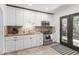 Modern kitchen featuring white cabinetry, stainless steel appliances, granite countertops, and a convenient tile backsplash at 5051 E Lafayette Blvd, Phoenix, AZ 85018