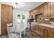 Charming kitchen with wood cabinets, stainless steel appliances, and a cozy dining area with access to the backyard at 5051 E Lafayette Blvd, Phoenix, AZ 85018