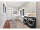 Well-organized laundry room with modern washer and dryer, ample cabinet space, and brick flooring at 5051 E Lafayette Blvd, Phoenix, AZ 85018