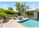 Inviting backyard pool with stone fireplace and covered dining area, perfect for outdoor entertaining at 5051 E Lafayette Blvd, Phoenix, AZ 85018