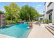Beautiful backyard pool area with lush landscaping, a waterfall feature, and comfortable seating for outdoor enjoyment at 5051 E Lafayette Blvd, Phoenix, AZ 85018