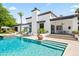 Stunning backyard with a refreshing pool and stylish outdoor lounge area with white stucco home at 5051 E Lafayette Blvd, Phoenix, AZ 85018