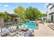 Backyard oasis with a sparkling pool, an outdoor dining area, and lounge furniture for ultimate relaxation and entertainment at 5051 E Lafayette Blvd, Phoenix, AZ 85018