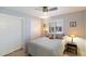 Comfortable bedroom featuring a ceiling fan, closet with sliding doors, and shuttered windows at 520 S Greenfield Rd # 7, Mesa, AZ 85206