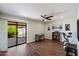 Versatile bonus room with sliding glass doors leading to back patio, ceiling fan, and wood flooring at 520 S Greenfield Rd # 7, Mesa, AZ 85206