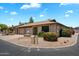 Exterior of a brick single-story home with a two-car garage and well-maintained landscaping at 520 S Greenfield Rd # 7, Mesa, AZ 85206