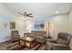 Comfortable living room with neutral walls, wood floors, ceiling fan, and contemporary furnishings at 520 S Greenfield Rd # 7, Mesa, AZ 85206
