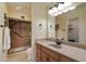 This main bathroom features a marble countertop, modern lighting, a walk-in shower, and a closet at 520 S Greenfield Rd # 7, Mesa, AZ 85206