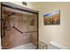 Close-up of the main bathroom shower showcasing marble-like walls, glass door, and shower head at 520 S Greenfield Rd # 7, Mesa, AZ 85206