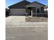 Charming single-story home featuring a two-car garage, neutral stucco, and decorative stone accents enhancing curb appeal at 5722 E Iris Dr, Florence, AZ 85132