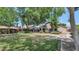 Beautifully landscaped backyard with ample green space, mature trees, and a gazebo for relaxing outdoors at 5733 E Jaeger St, Mesa, AZ 85205