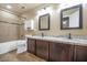 Bathroom featuring double sinks, granite countertops, framed mirrors and tile flooring at 5733 E Jaeger St, Mesa, AZ 85205