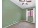 Bedroom featuring plush carpet, ceiling fan and a window with natural lighting at 5733 E Jaeger St, Mesa, AZ 85205