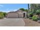 Charming single-story home boasts a stone facade, desert landscaping, and three-car garage at 5733 E Jaeger St, Mesa, AZ 85205