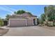 Charming single-story home with desert landscaping and a spacious three-car garage at 5733 E Jaeger St, Mesa, AZ 85205