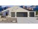 Charming single-story home with a three-car garage and desert landscaping against a mountain backdrop at 5830 E Freesia Ln, San Tan Valley, AZ 85140