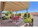 Landscaped backyard featuring a pergola-covered patio and lush greenery, perfect for outdoor living at 60 S Agua Fria Ln, Casa Grande, AZ 85194
