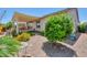 Serene backyard featuring a covered patio, low-maintenance landscaping, and charming water feature at 60 S Agua Fria Ln, Casa Grande, AZ 85194