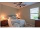 Cozy bedroom with soft lighting, ceiling fan, and a comfortable bed for relaxation at 60 S Agua Fria Ln, Casa Grande, AZ 85194