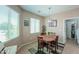 Cozy dining area with wood table, four chairs, natural light, and decorative accents at 60 S Agua Fria Ln, Casa Grande, AZ 85194