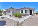 Charming single-story home with desert landscaping and walkway leading to the front door at 60 S Agua Fria Ln, Casa Grande, AZ 85194