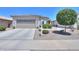 Charming single-story home with tile roof, desert landscaping, and a two-car garage at 60 S Agua Fria Ln, Casa Grande, AZ 85194