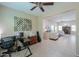 Comfortable home office features a workstation, guitar, and decor rings on the wall near the spacious living room area at 60 S Agua Fria Ln, Casa Grande, AZ 85194