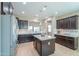 Bright kitchen with dark wood cabinets, granite counters, stainless steel fridge, and tile flooring at 60 S Agua Fria Ln, Casa Grande, AZ 85194