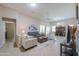 Spacious living room with tile floors, ceiling fan, comfortable seating, and ample natural light at 60 S Agua Fria Ln, Casa Grande, AZ 85194